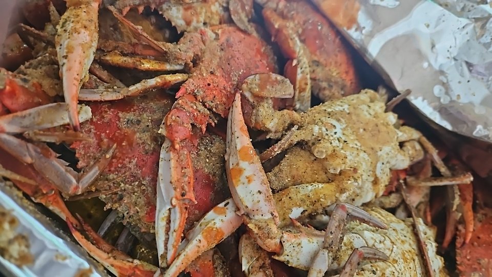 Takeout containers filled with crab and shrimp.